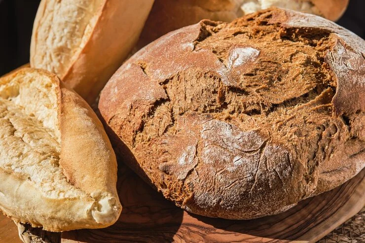 A selection of rustic bread on a bakery table